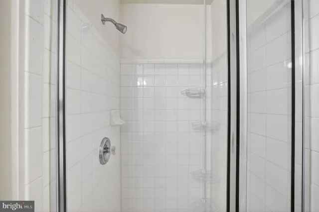 a bathroom with a glass shower door