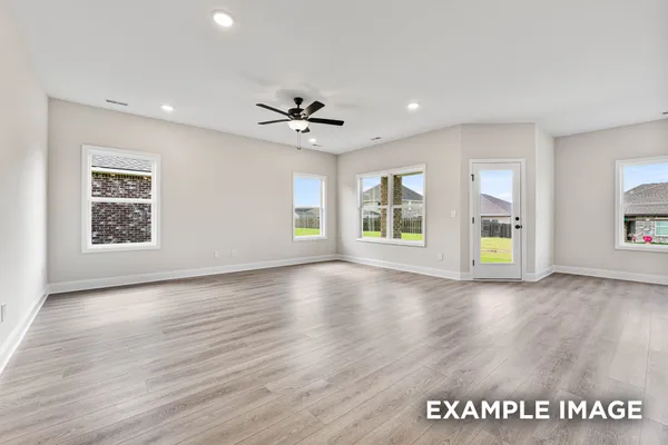 a large white kitchen with kitchen island a sink stainless steel appliances and cabinets