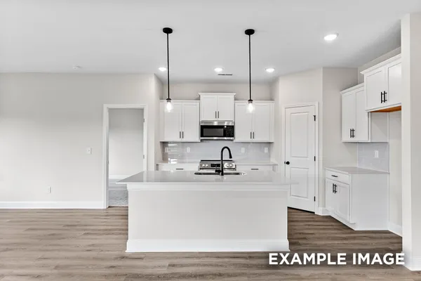 a kitchen with kitchen island granite countertop a sink a center island stainless steel appliances and cabinets