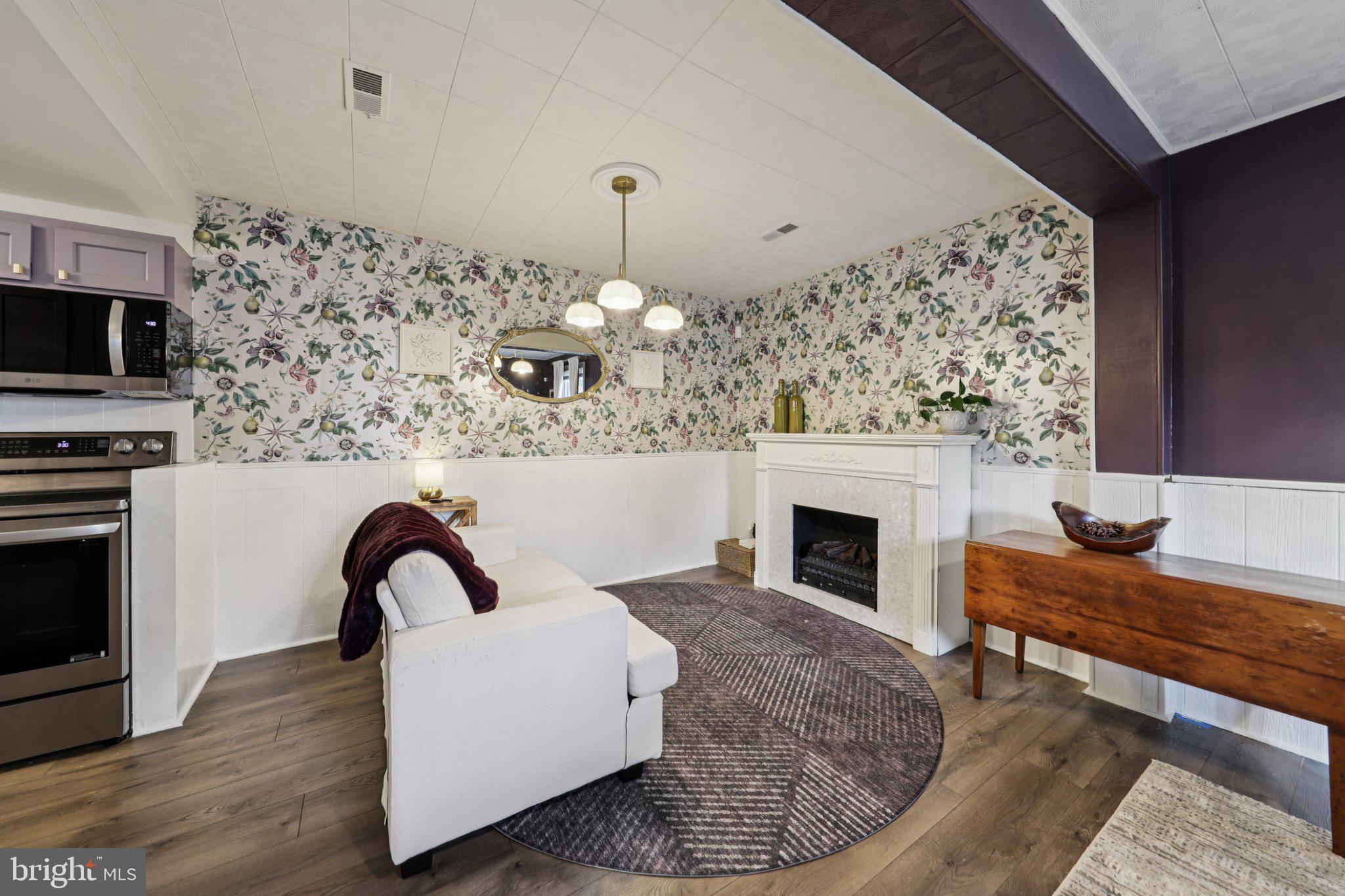 6501 Sligo Parkway Hyattsville, MD 20782 - Photo 11 of 25 a living room with furniture a fireplace and a flat screen tv
