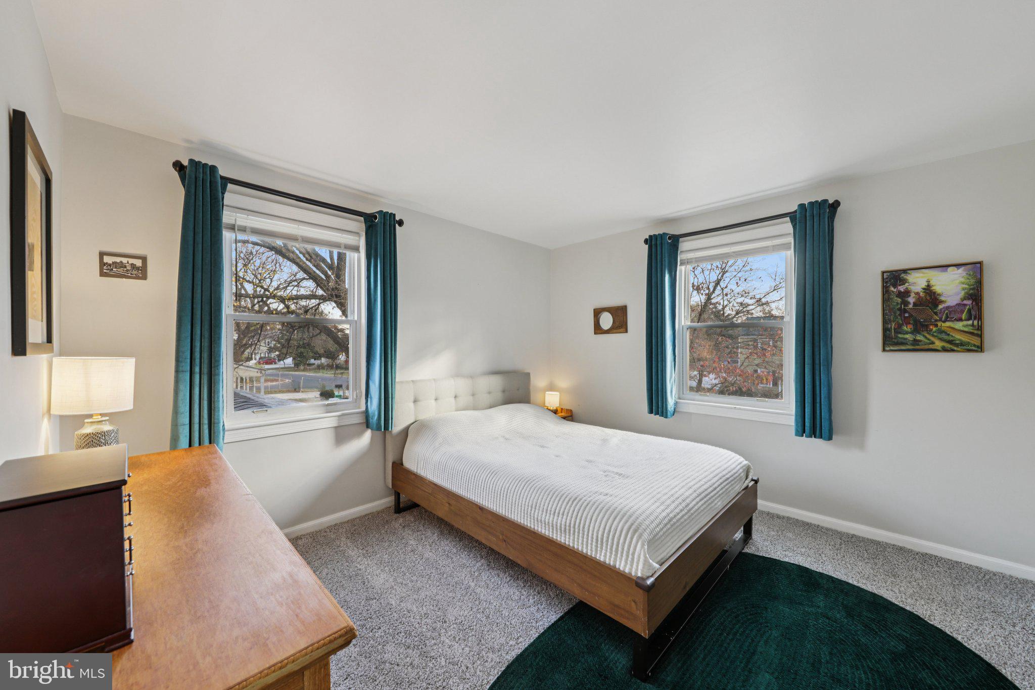 6501 Sligo Parkway Hyattsville, MD 20782 - Photo 15 of 25 a bedroom with a large bed and a large window