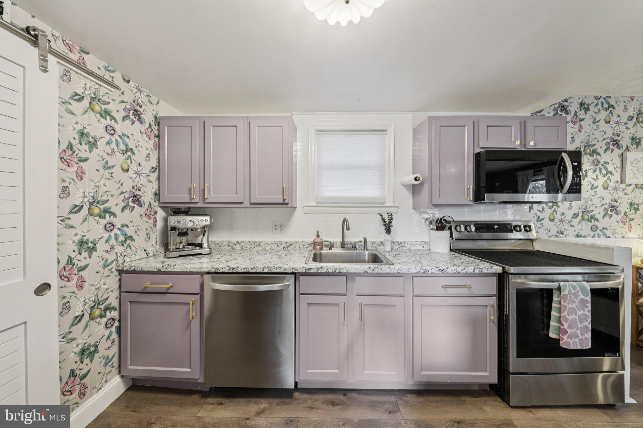 6501 Sligo Parkway Hyattsville, MD 20782 - Photo 8 of 25 a kitchen with stainless steel appliances a stove a sink and a microwave