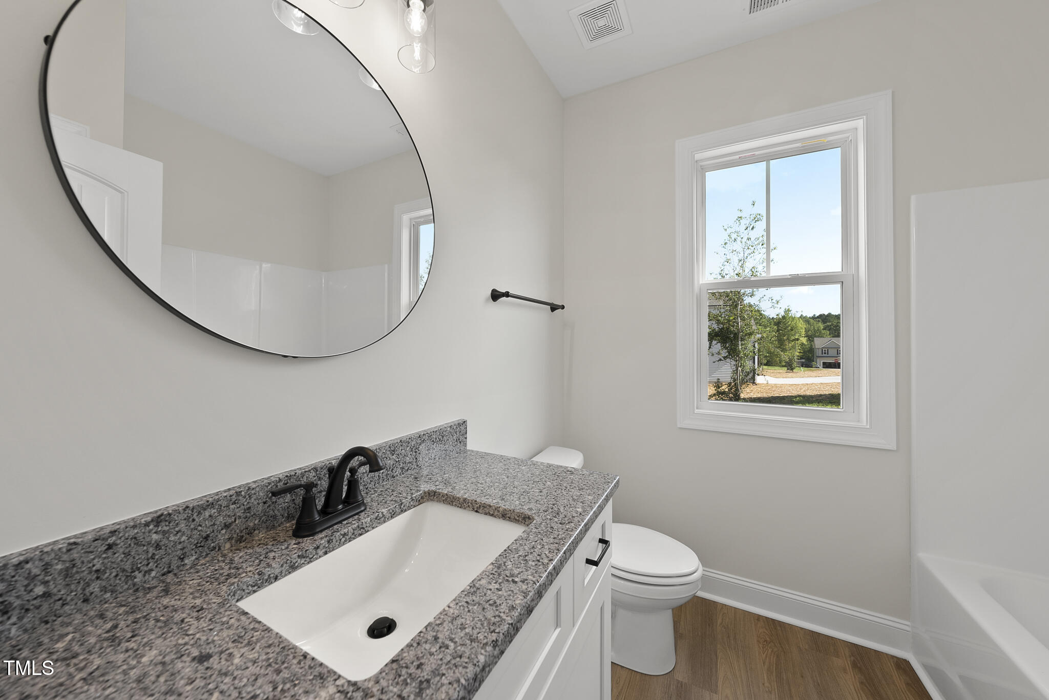30 Morning Dew Way Spring Hope, NC 27882 - Photo 13 of 23 a bathroom with a granite countertop sink a toilet and mirror