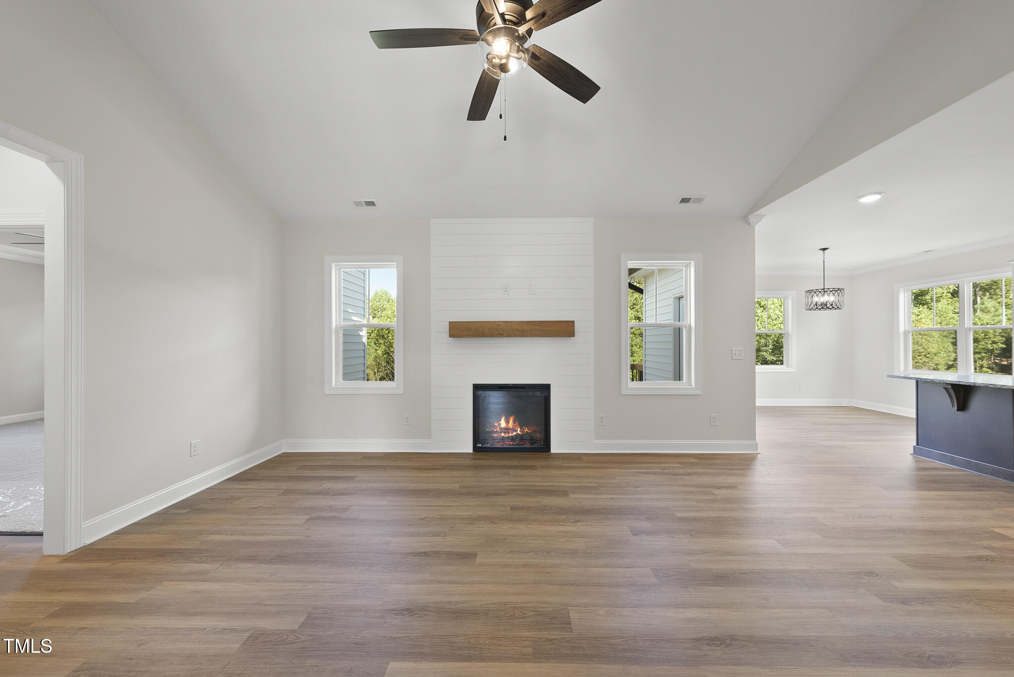 30 Morning Dew Way Spring Hope, NC 27882 - Photo 3 of 23 a view of a livingroom with a fireplace a ceiling fan and windows