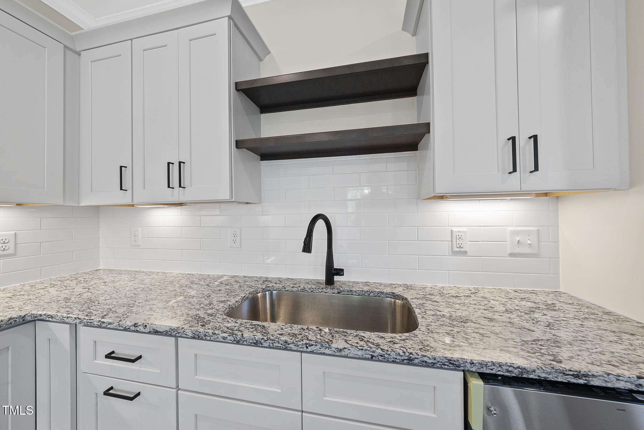 30 Morning Dew Way Spring Hope, NC 27882 - Photo 6 of 23 a kitchen with granite countertop white cabinets and a sink