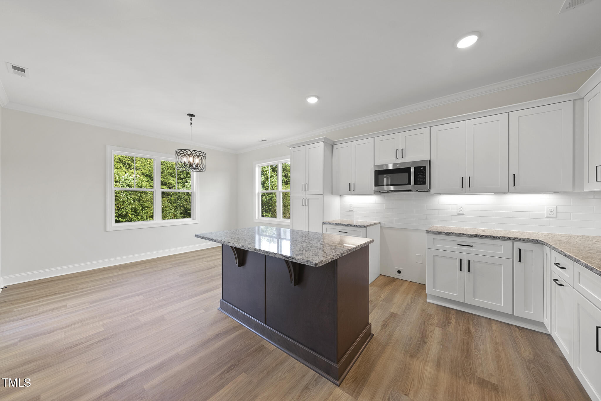 30 Morning Dew Way Spring Hope, NC 27882 - Photo 7 of 23 a kitchen with kitchen island granite countertop a sink window and cabinets