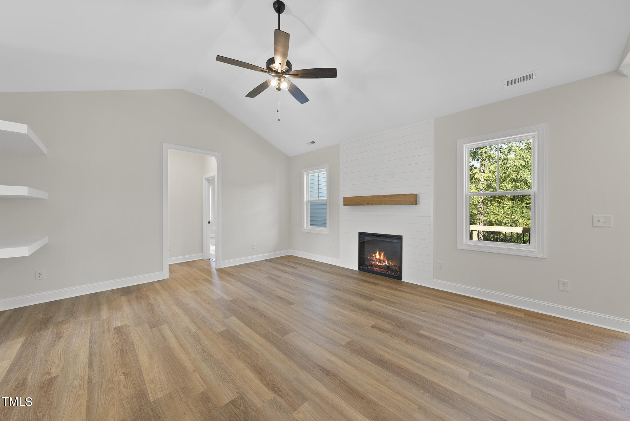 30 Morning Dew Way Spring Hope, NC 27882 - Photo 9 of 23 a view of empty room with wooden floor fireplace and window