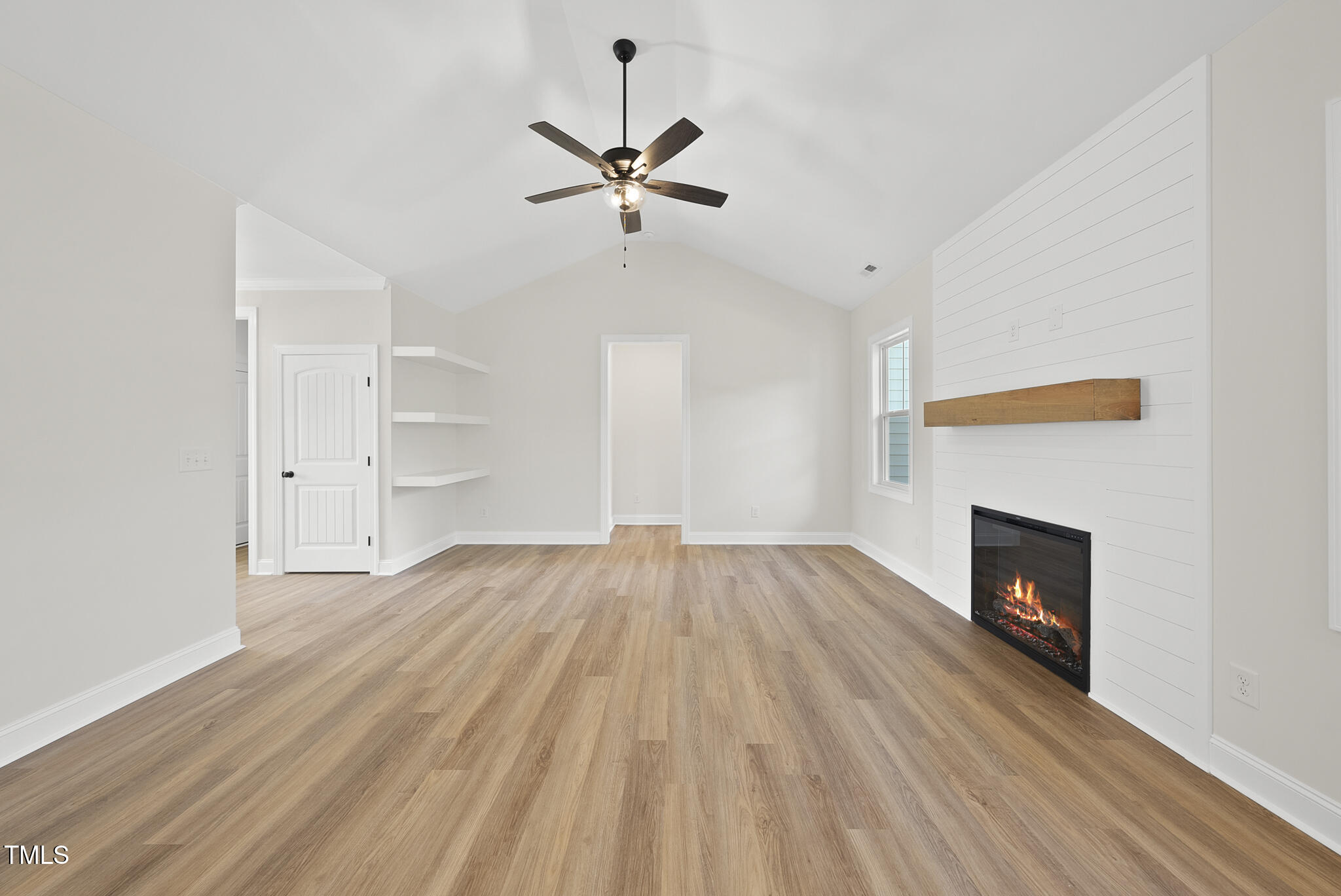 30 Morning Dew Way Spring Hope, NC 27882 - Photo 10 of 23 an empty room with wooden floor fireplace and windows