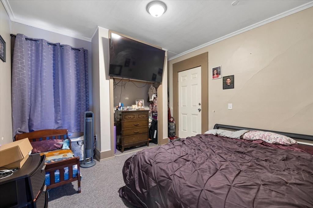 19 Schofield Avenue Dudley, MA 01571 - Photo 18 of 31 a bedroom with a bed and a television