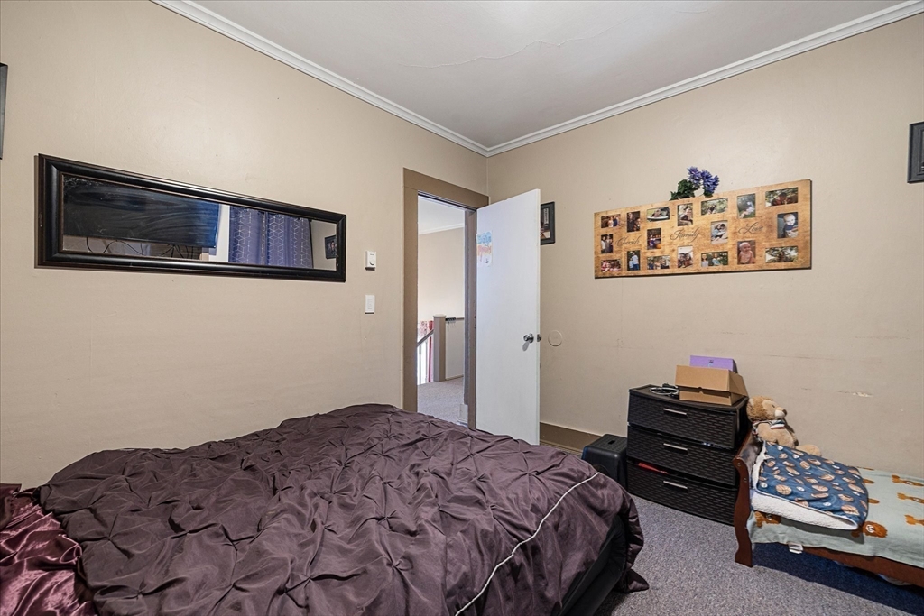 19 Schofield Avenue Dudley, MA 01571 - Photo 19 of 31 a bedroom with a bed and a couch