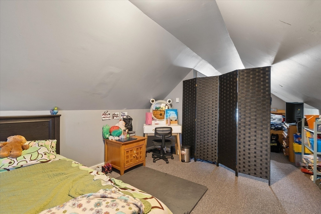 19 Schofield Avenue Dudley, MA 01571 - Photo 22 of 31 a bedroom with a bed and a refrigerator