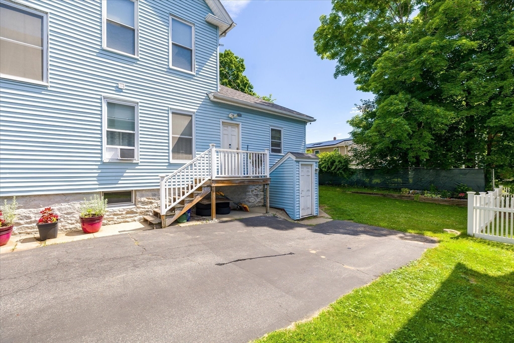 19 Schofield Avenue Dudley, MA 01571 - Photo 27 of 31 a view of backyard with a chair and a table