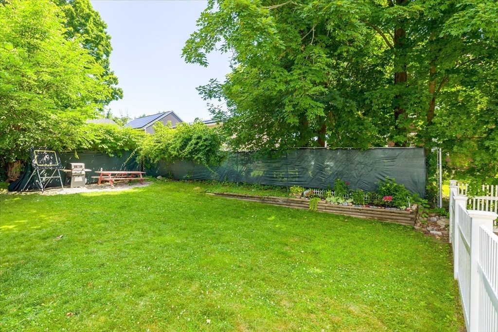 19 Schofield Avenue Dudley, MA 01571 - Photo 28 of 31 a view of a garden with a bench