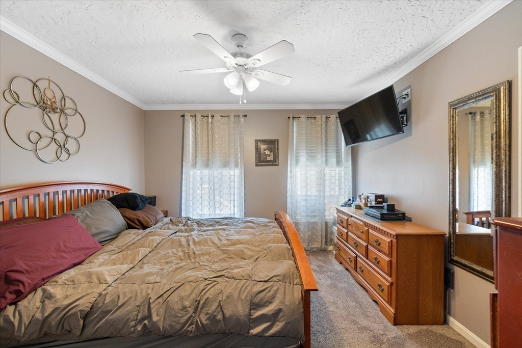 19 Schofield Avenue Dudley, MA 01571 - Photo 7 of 31 a bedroom with a bed and a flat screen tv