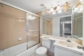 a bathroom with a sink toilet and shower