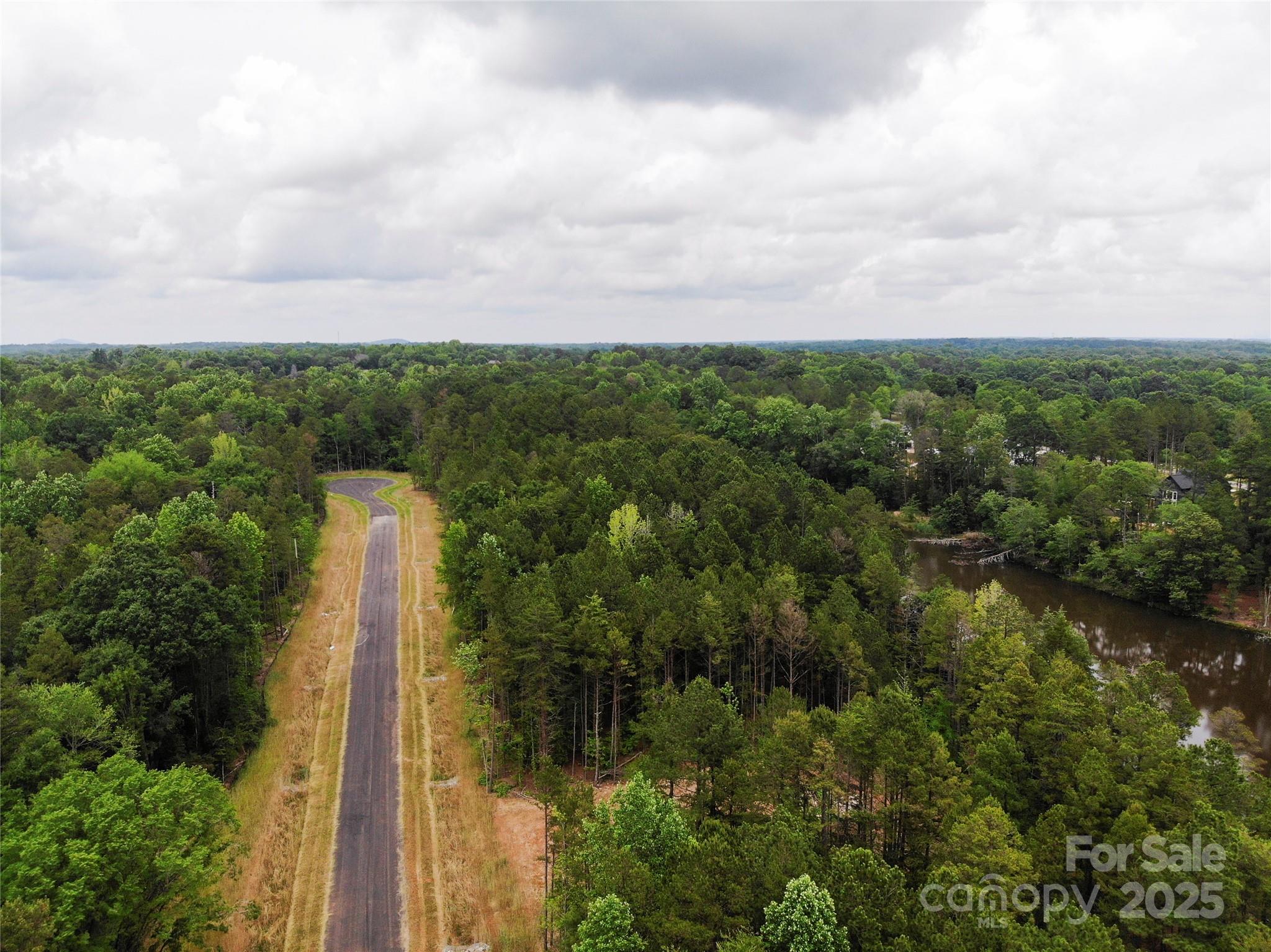 Lot 37 Snow Goose Walk Clover, SC 29710 - Photo 15 of 15 a view of a lake with a house in background