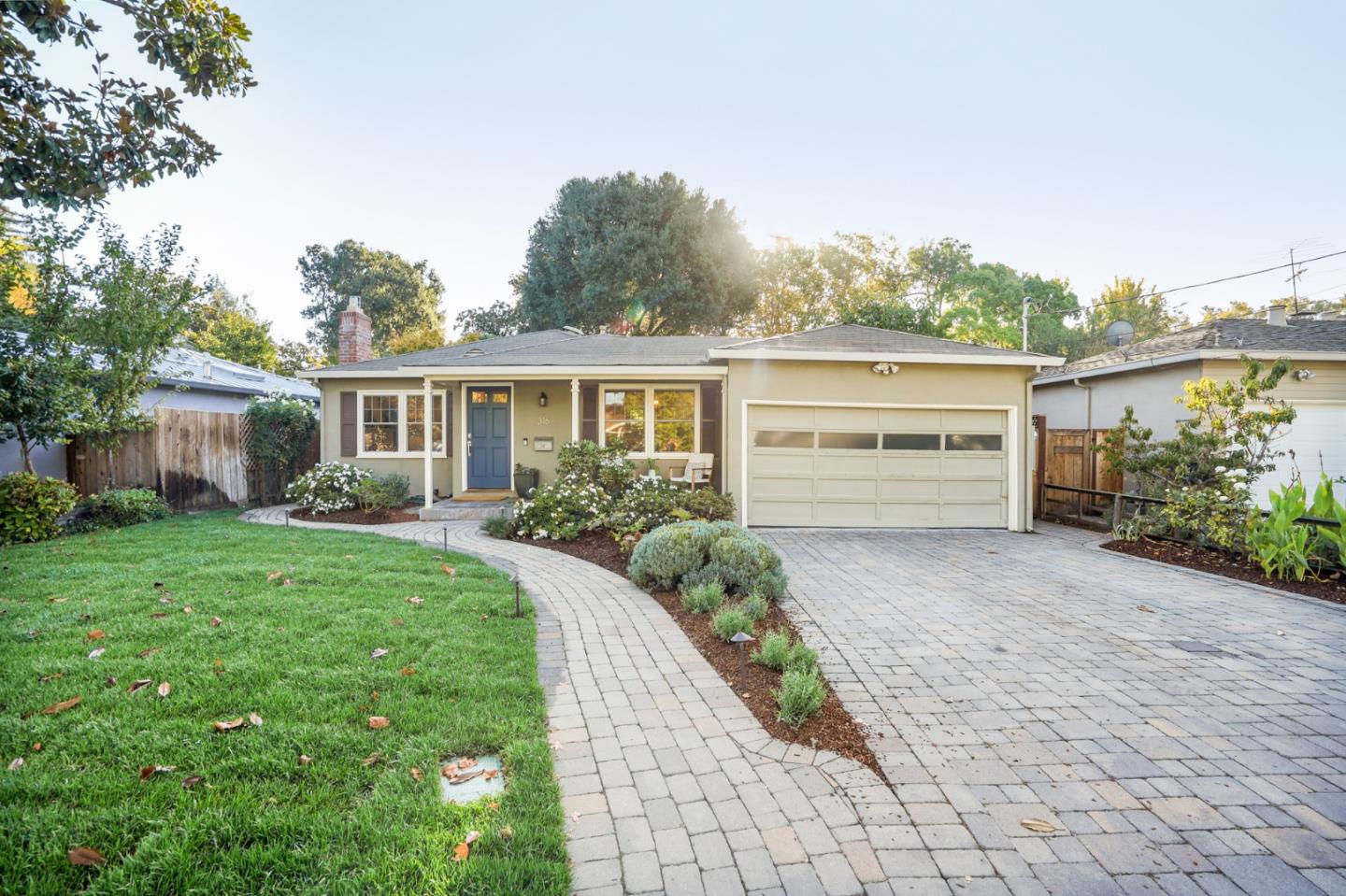 316 McKendry Drive Menlo Park, CA 94025 - Photo 2 of 21 a front view of a house with a yard and a garage