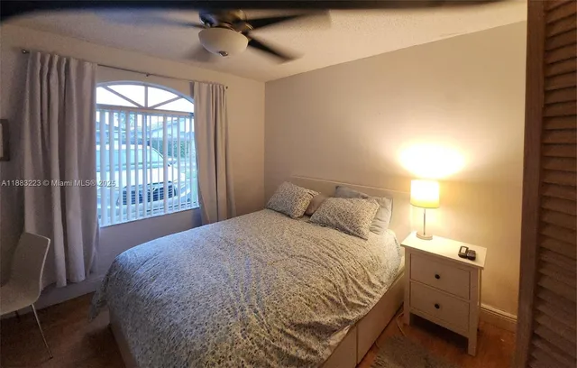 a bedroom with a large bed and a window