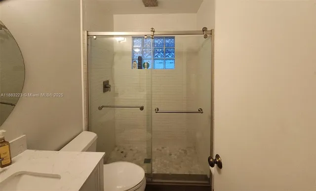 a bathroom with a toilet and a shower