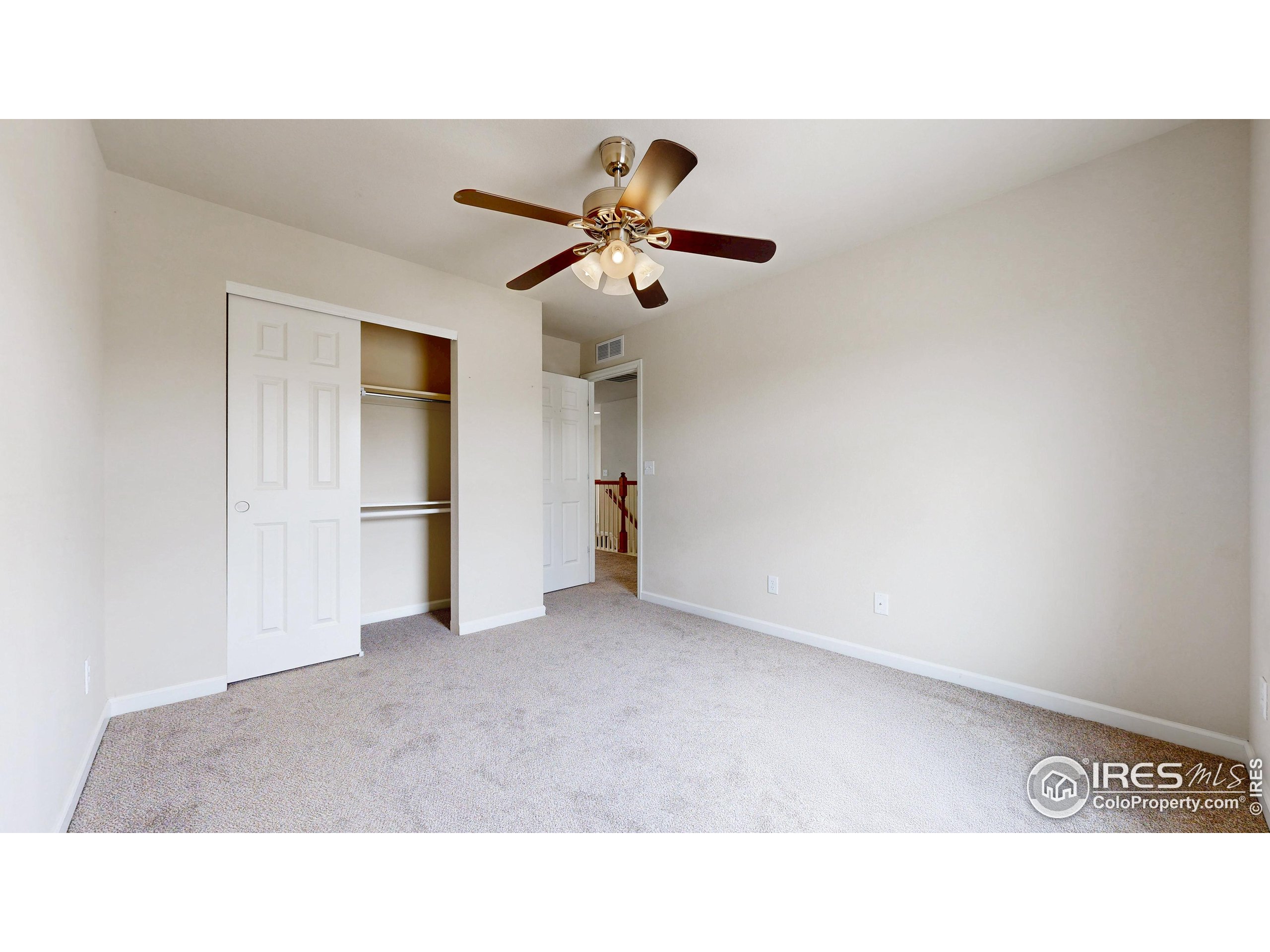 6748 Rainier Road Timnath, CO 80547 - Photo 23 of 34 a open living room with a ceiling fan