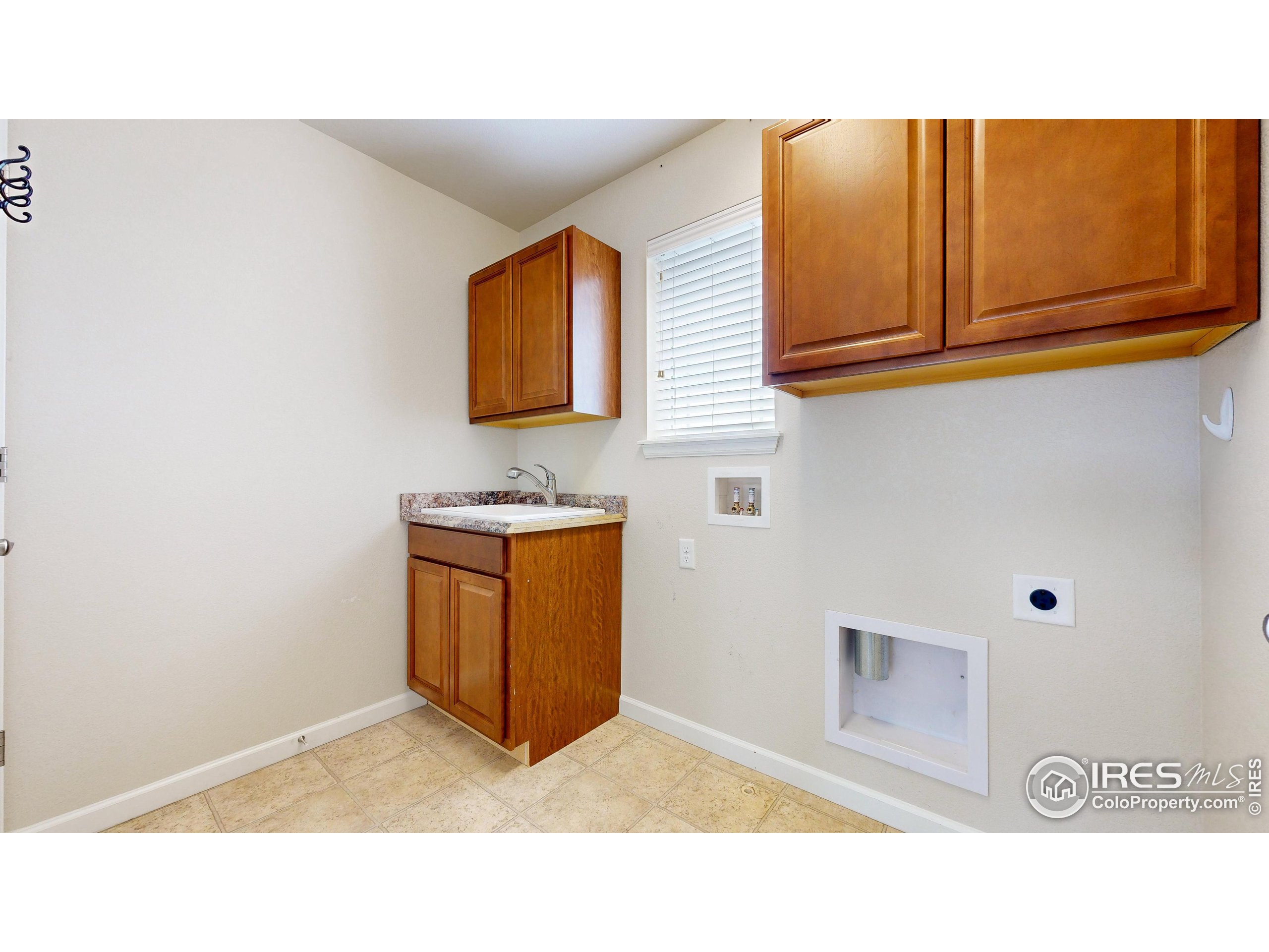 6748 Rainier Road Timnath, CO 80547 - Photo 26 of 34 a kitchen with a sink and cabinets