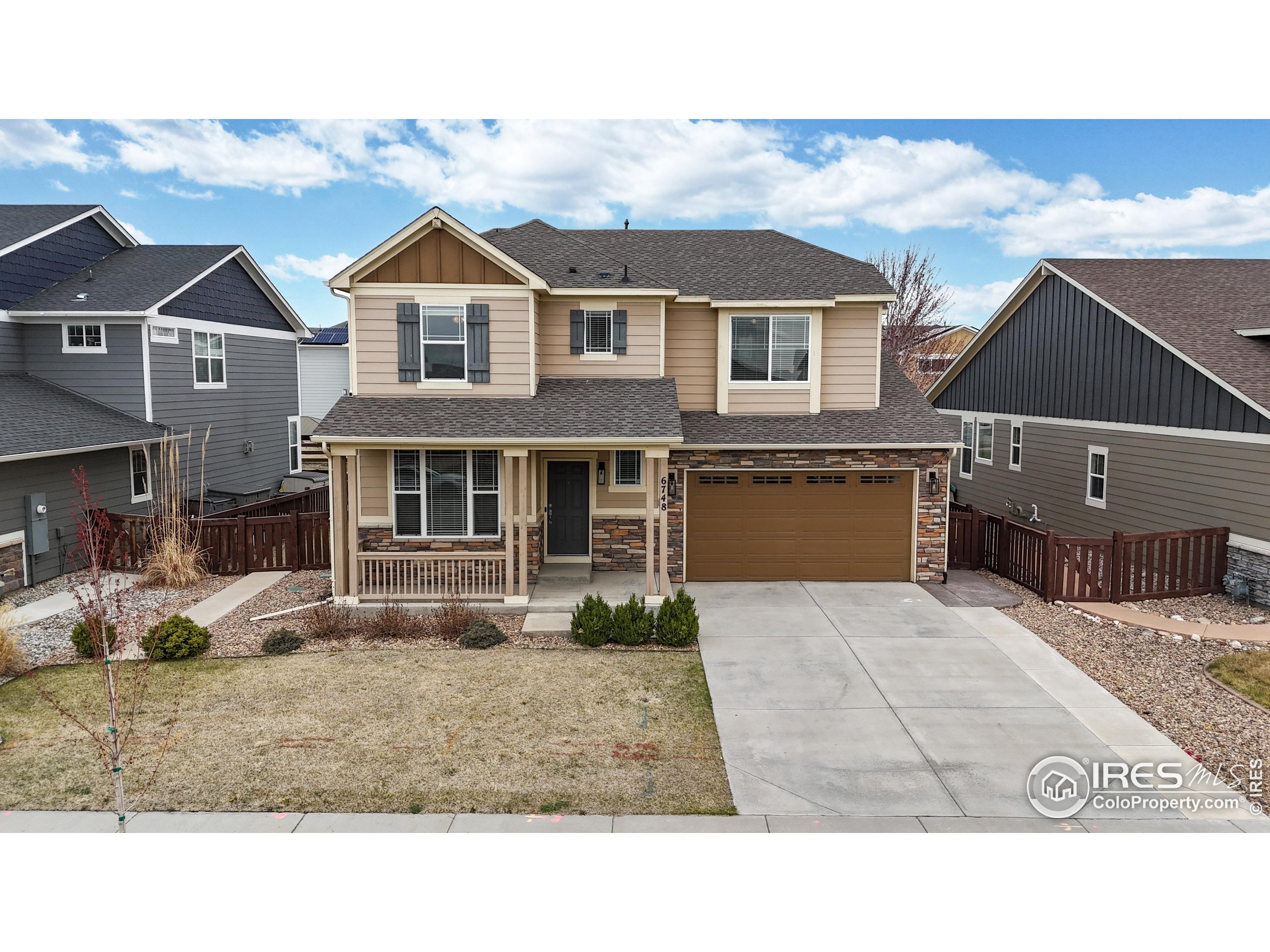 6748 Rainier Road Timnath, CO 80547 - Photo 29 of 34 a front view of a house with a yard