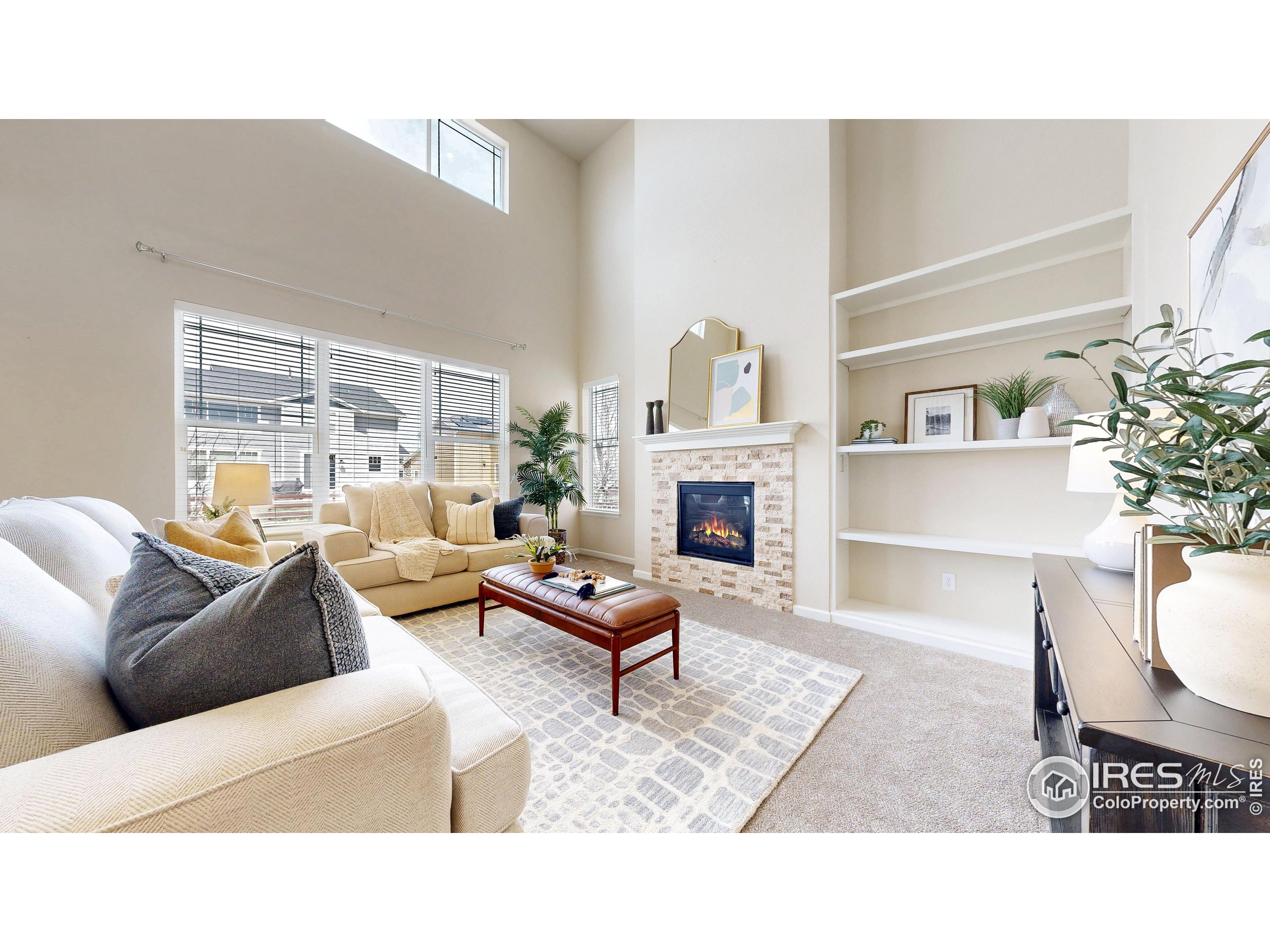 6748 Rainier Road Timnath, CO 80547 - Photo 3 of 34 a living room with furniture and a fireplace