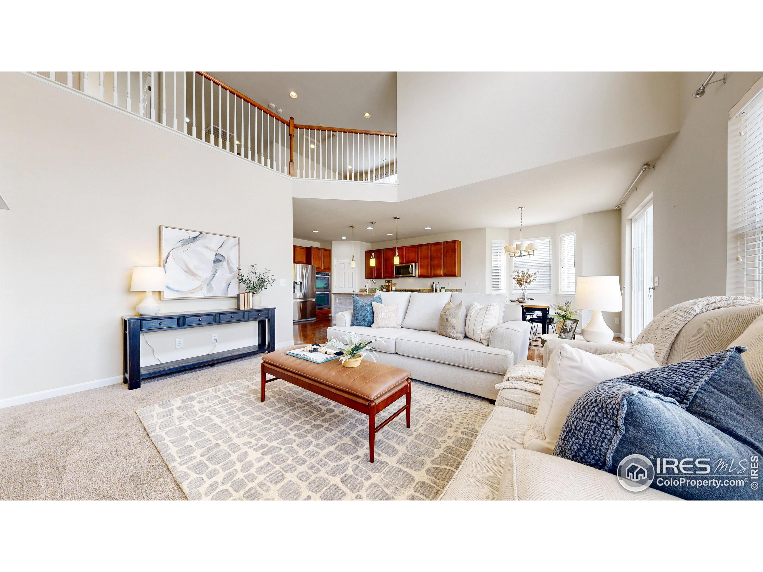 6748 Rainier Road Timnath, CO 80547 - Photo 5 of 34 a living room with furniture and wooden floor
