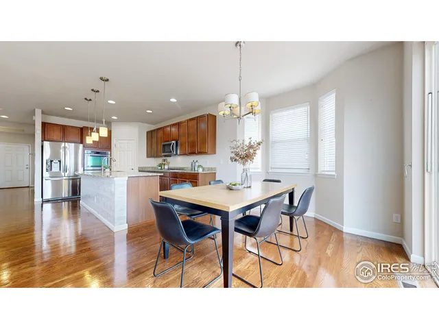a kitchen with a dining table chairs and granite counter tops