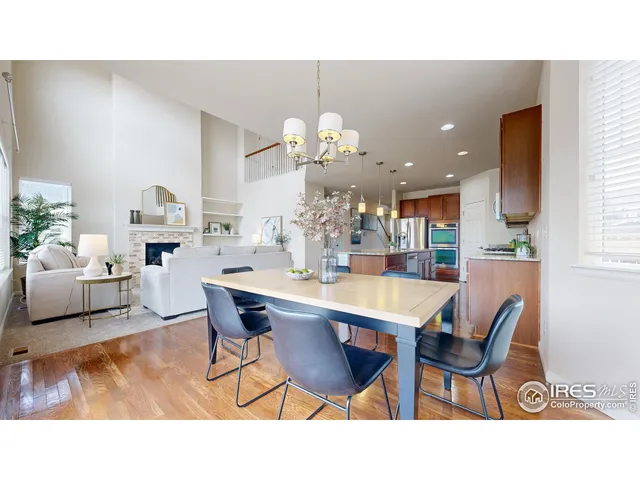 a living room with dining table furniture dining table and a chandelier