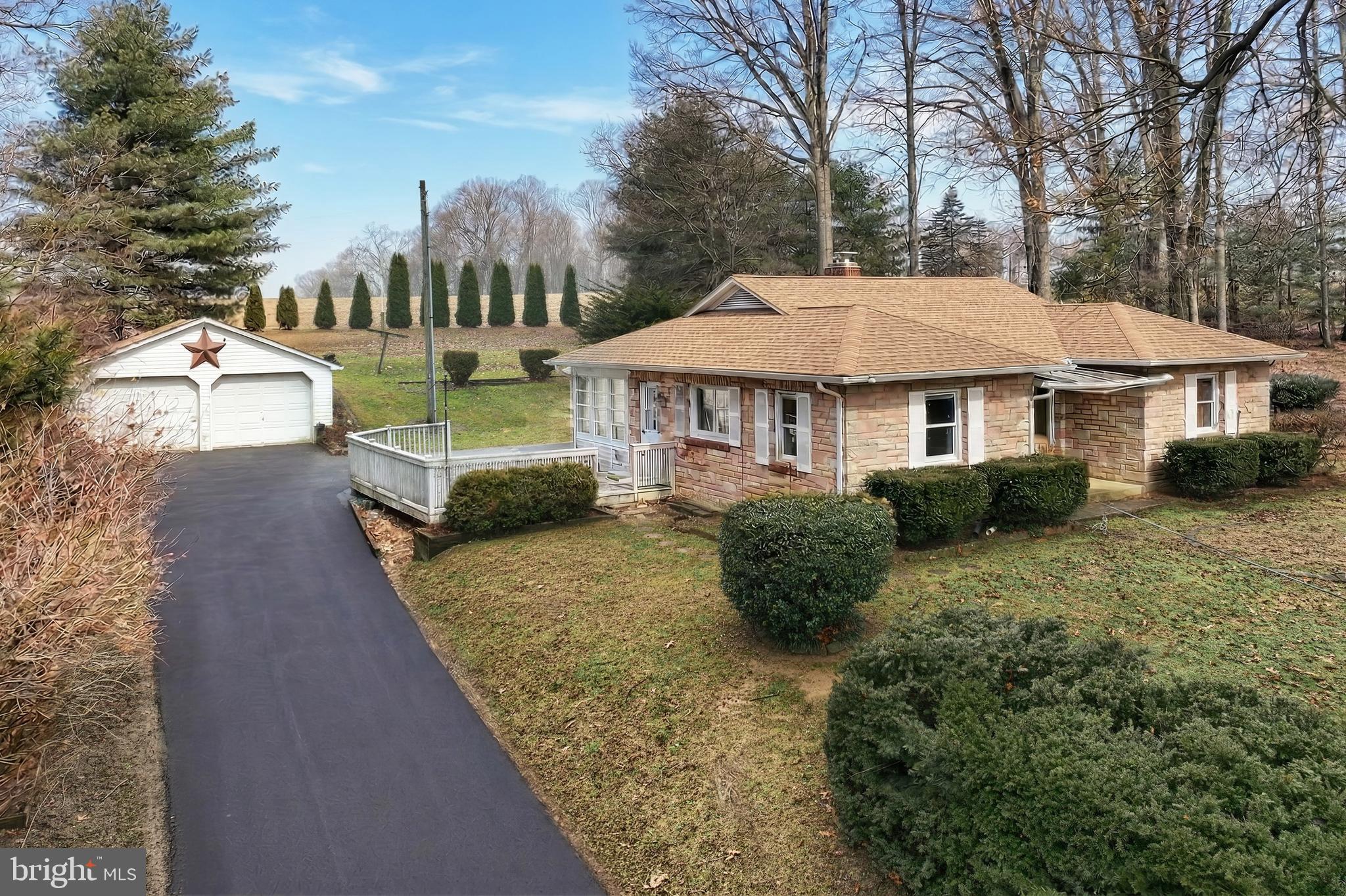 754 Bridgeton Road Fawn Grove, PA 17321 - Photo 2 of 42 a front view of a house with a yard and trees