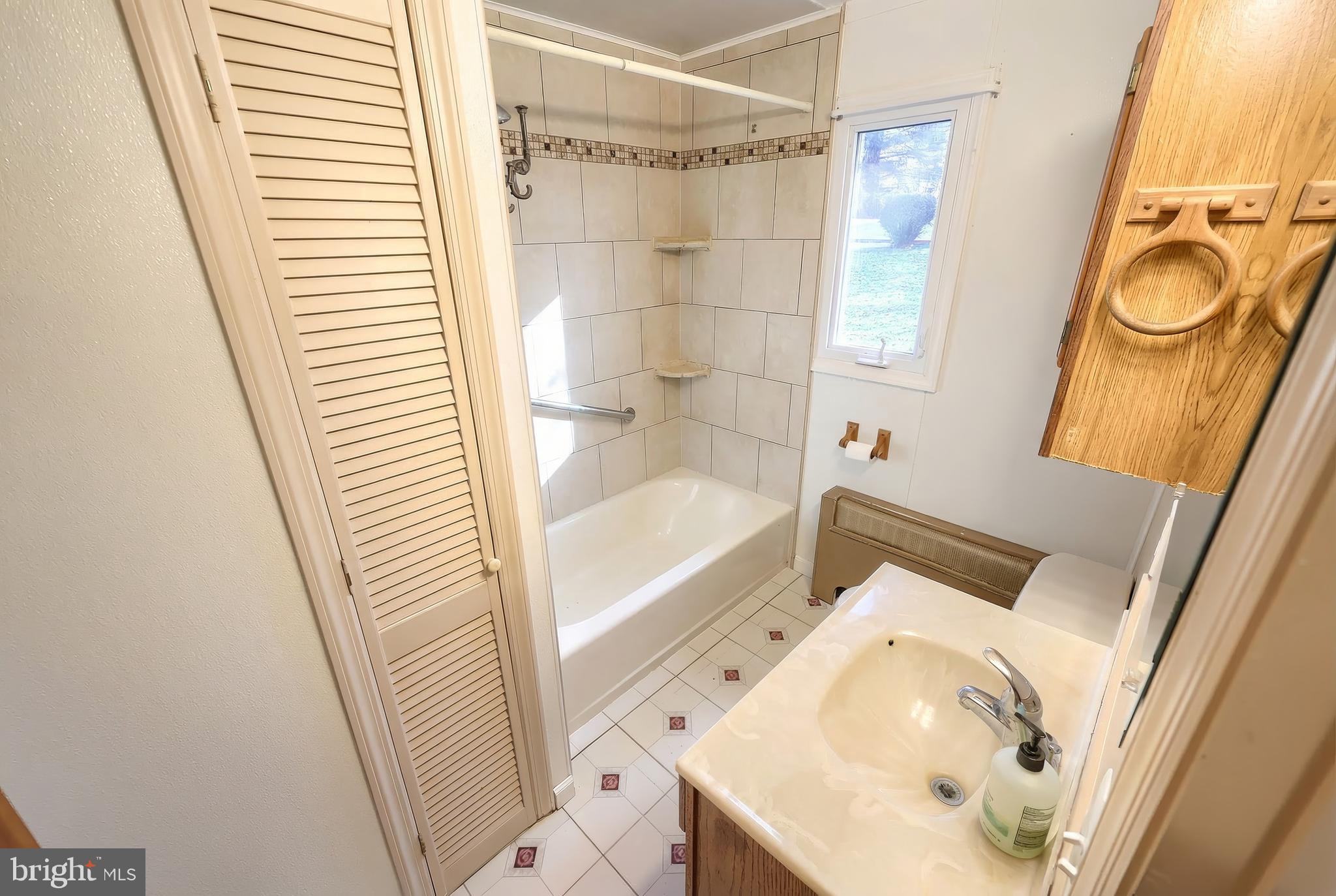 754 Bridgeton Road Fawn Grove, PA 17321 - Photo 34 of 42 a bathroom with a sink a mirror and a shower