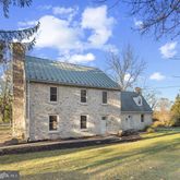 a front view of a house with a yard and balcony