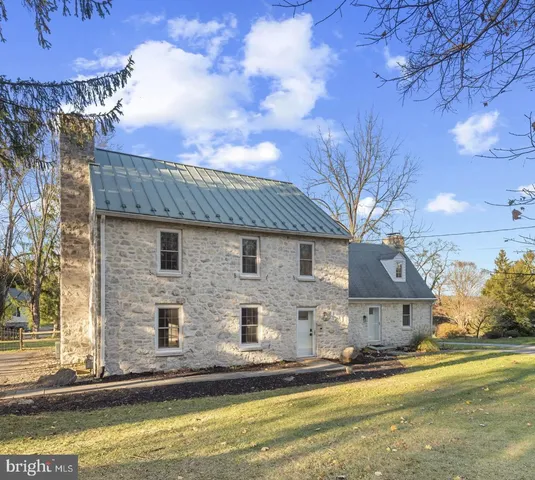 a front view of a house with a yard and balcony