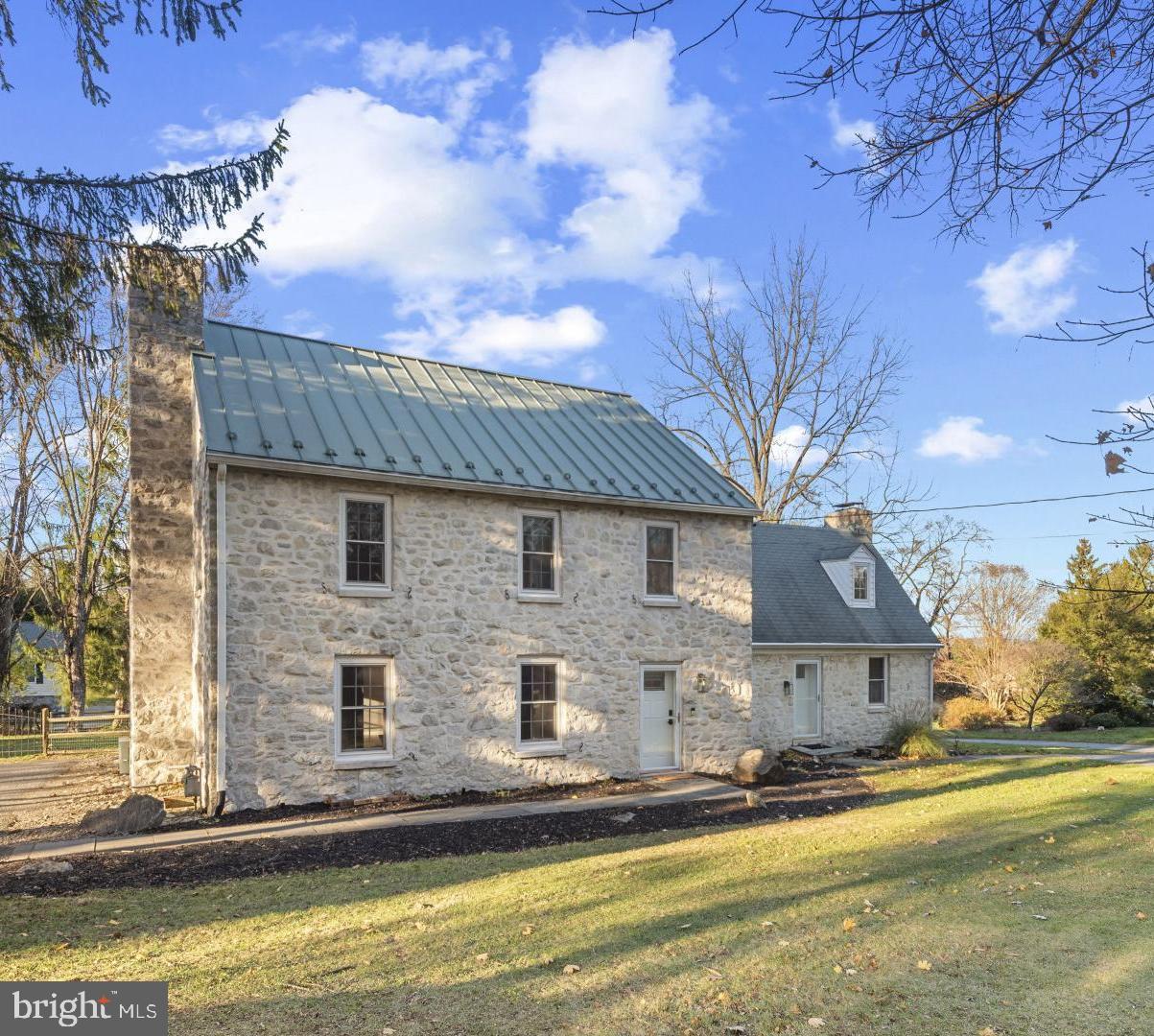 a front view of a house with a yard and balcony