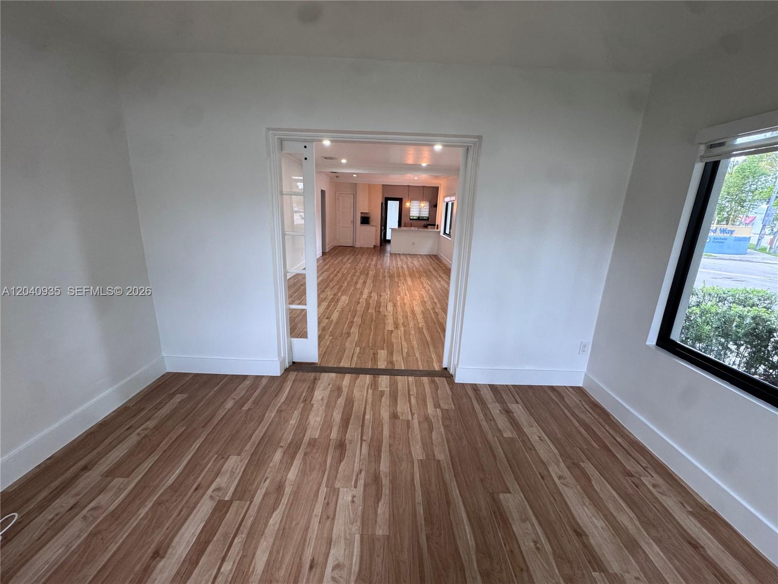 375 Southwest 32nd Road Miami, FL 33129 - Photo 28 of 44 a view of a room with wooden floor a ceiling fan and a window