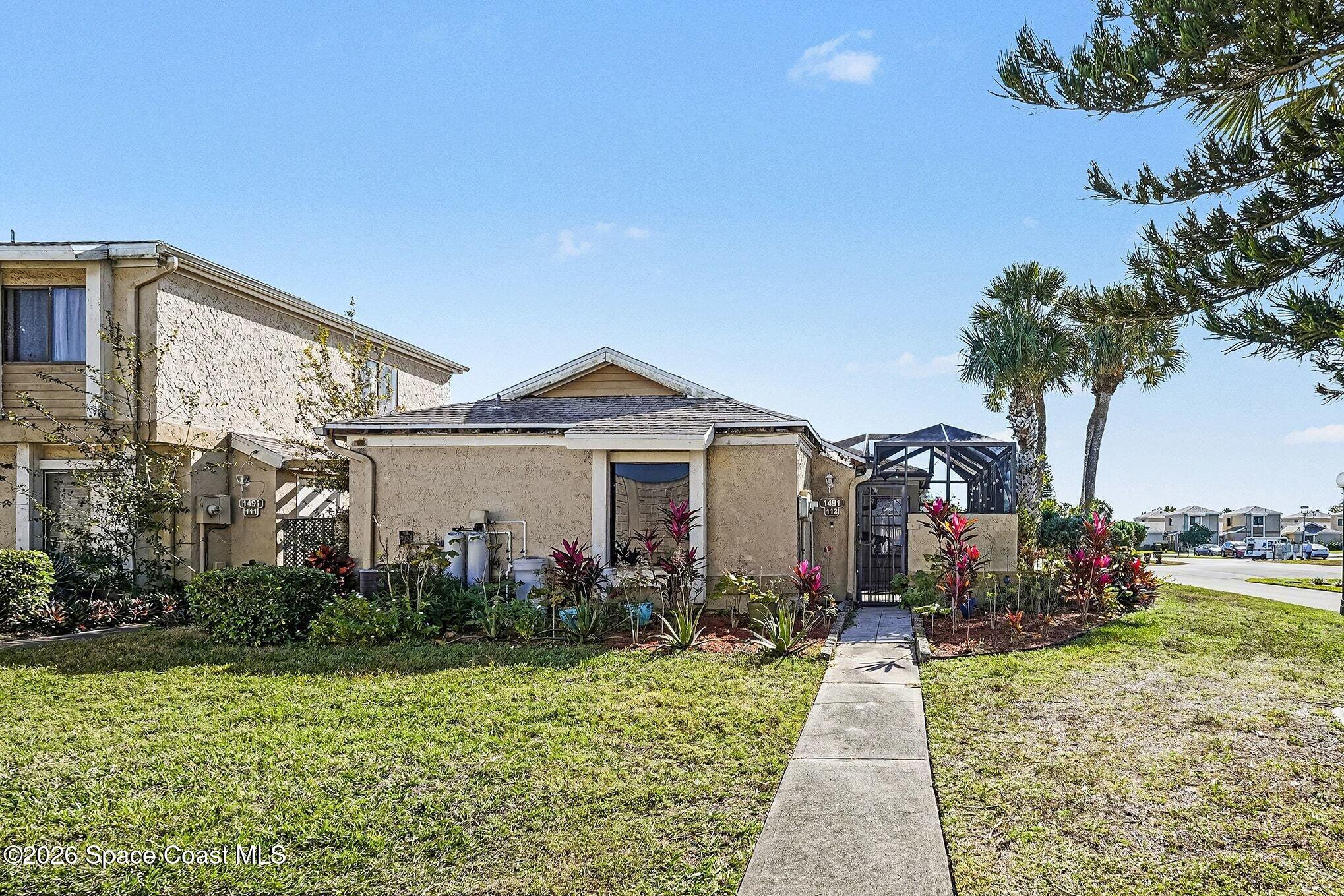 a front view of a house with garden