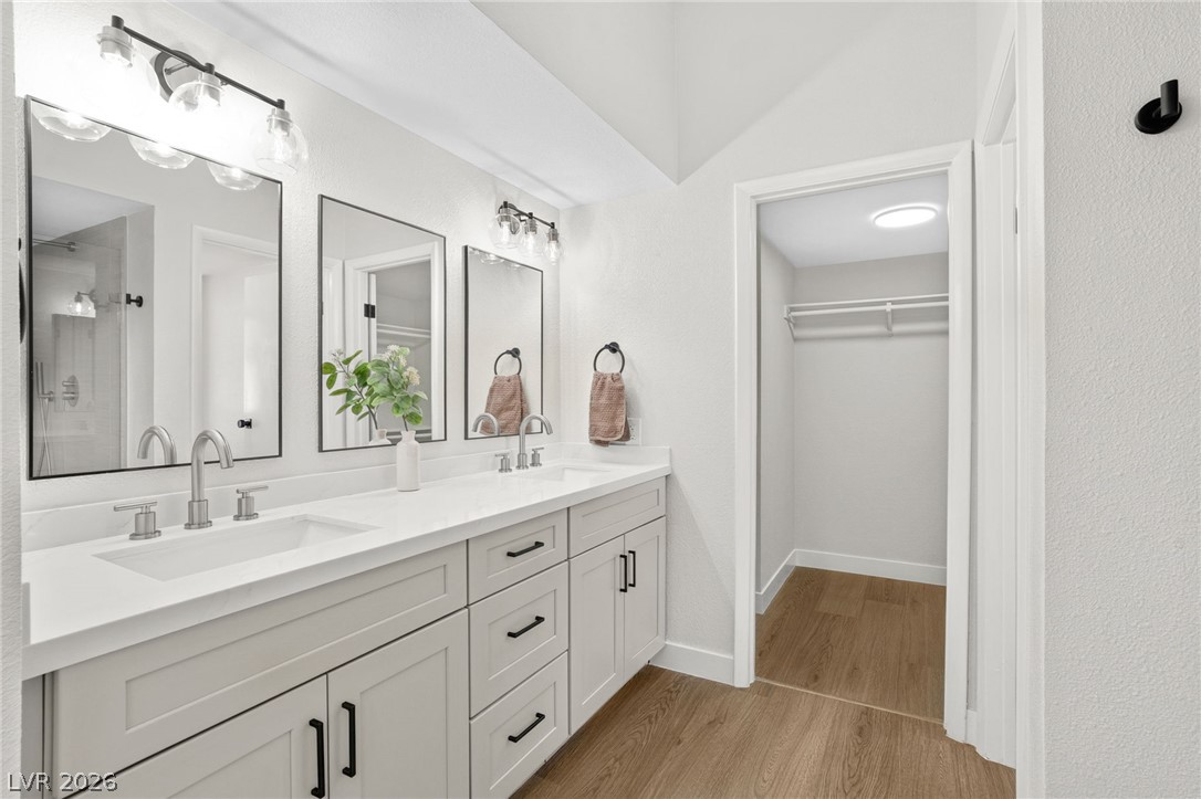 2681 Rungsted Street Las Vegas, NV 89142 - Photo 19 of 33 Dual vanity sinks with modern fixtures complement the well-lit space, offering both form and function.