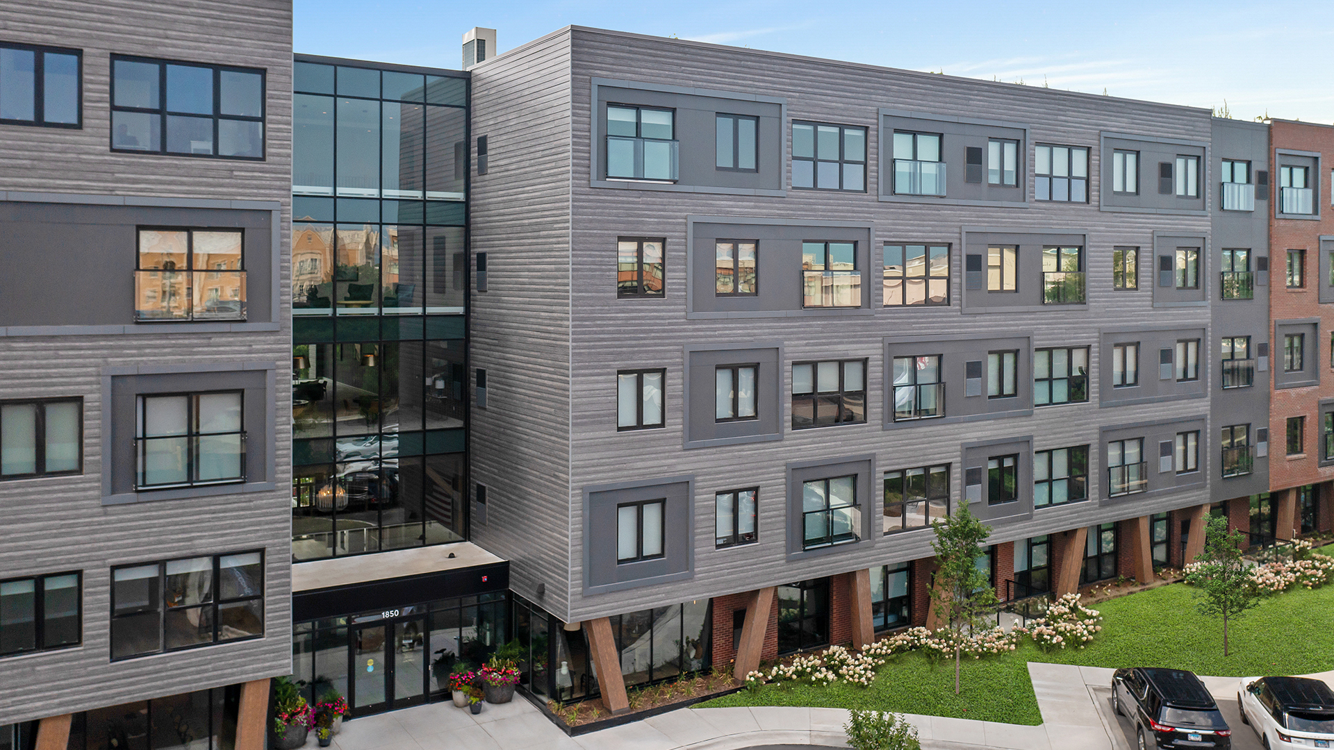 a front view of a residential apartment building with a yard