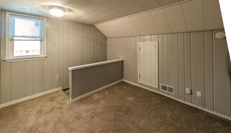41 Poplar Street Huron, OH 44839 - Photo 16 of 37 Loft featuring wooden walls, dark colored carpet, and lofted ceiling