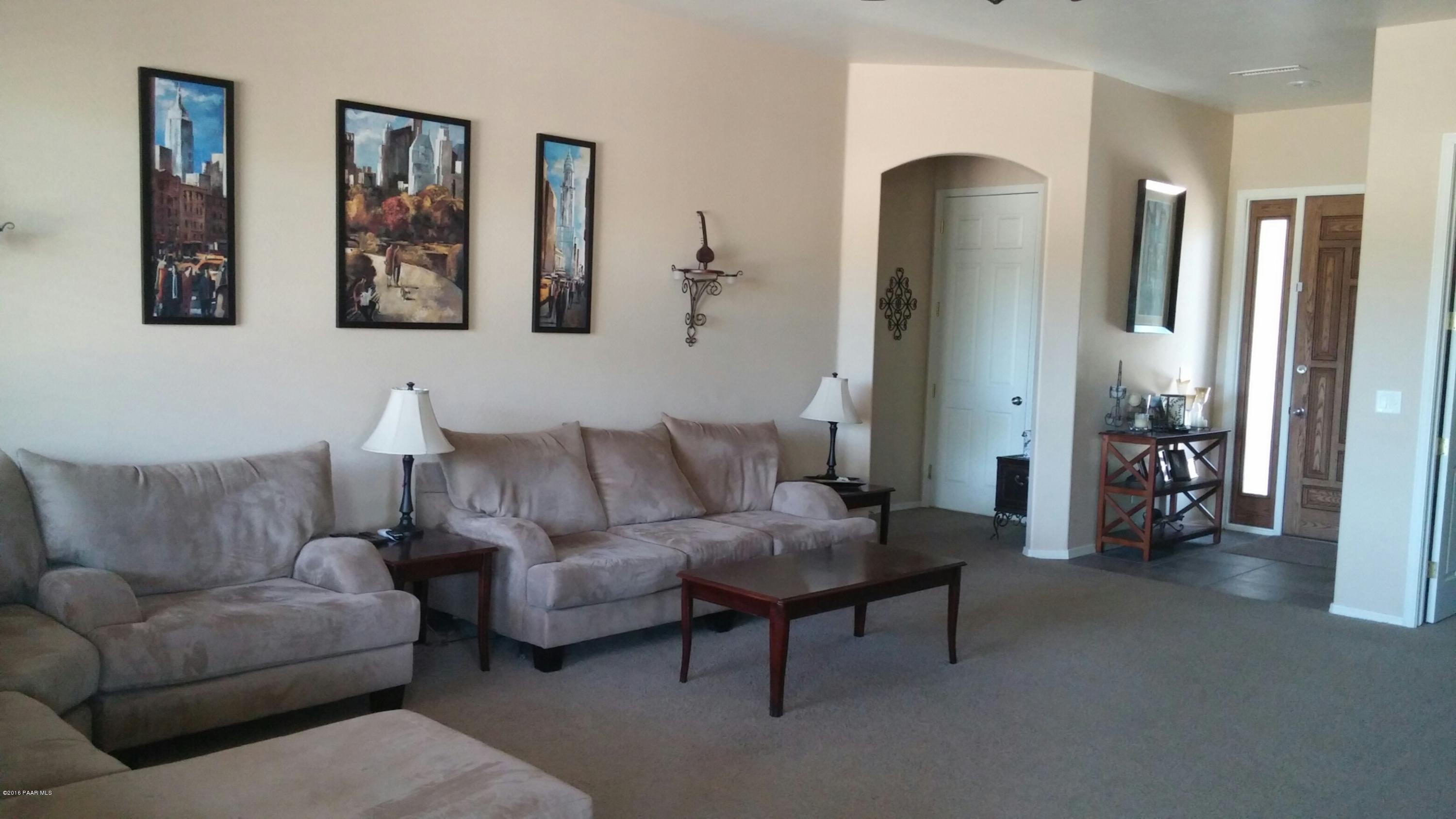 4702 Edgemont Road Prescott Valley, AZ 86314 - Photo 5 of 21 a living room with furniture and a large mirror