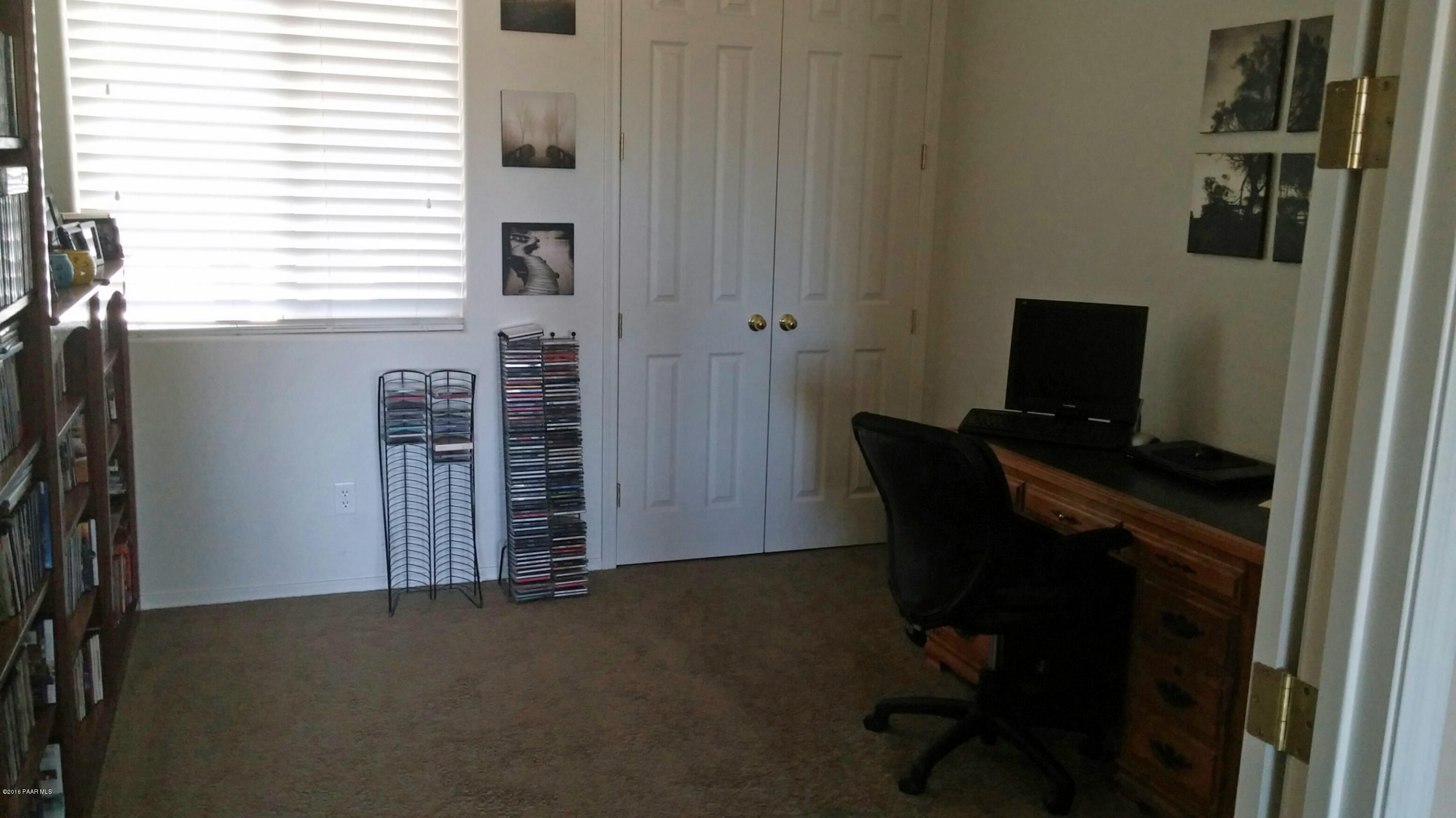 4702 Edgemont Road Prescott Valley, AZ 86314 - Photo 8 of 21 a view of a workspace with furniture and a window