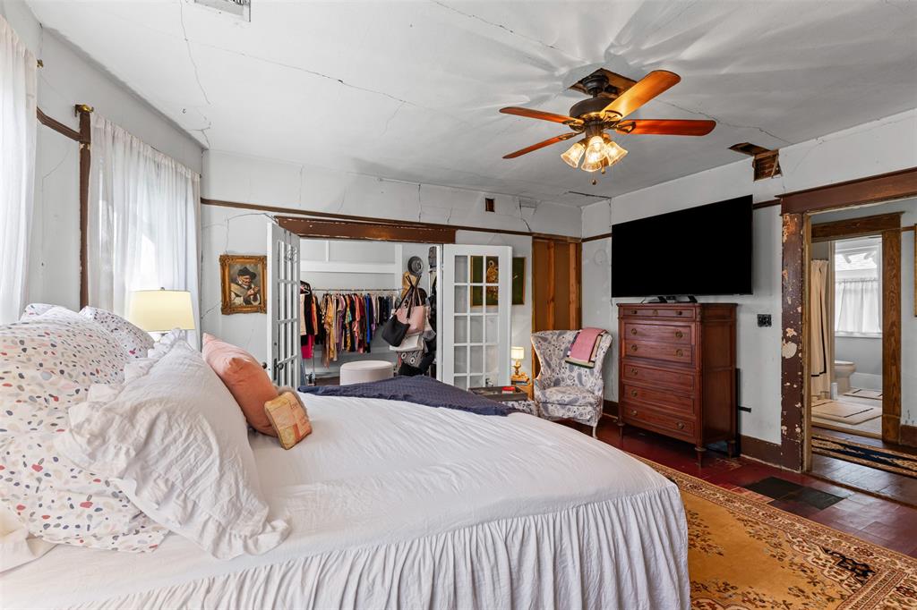 4606 East Side Avenue Dallas, TX 75226 - Photo 17 of 38 a bedroom with a bed and a flat tv screen on dresser