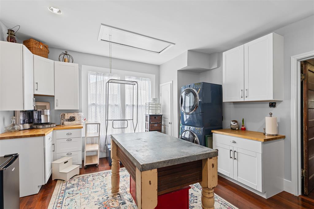 4606 East Side Avenue Dallas, TX 75226 - Photo 19 of 38 a kitchen with a stove a sink dishwasher and a refrigerator with wooden floor