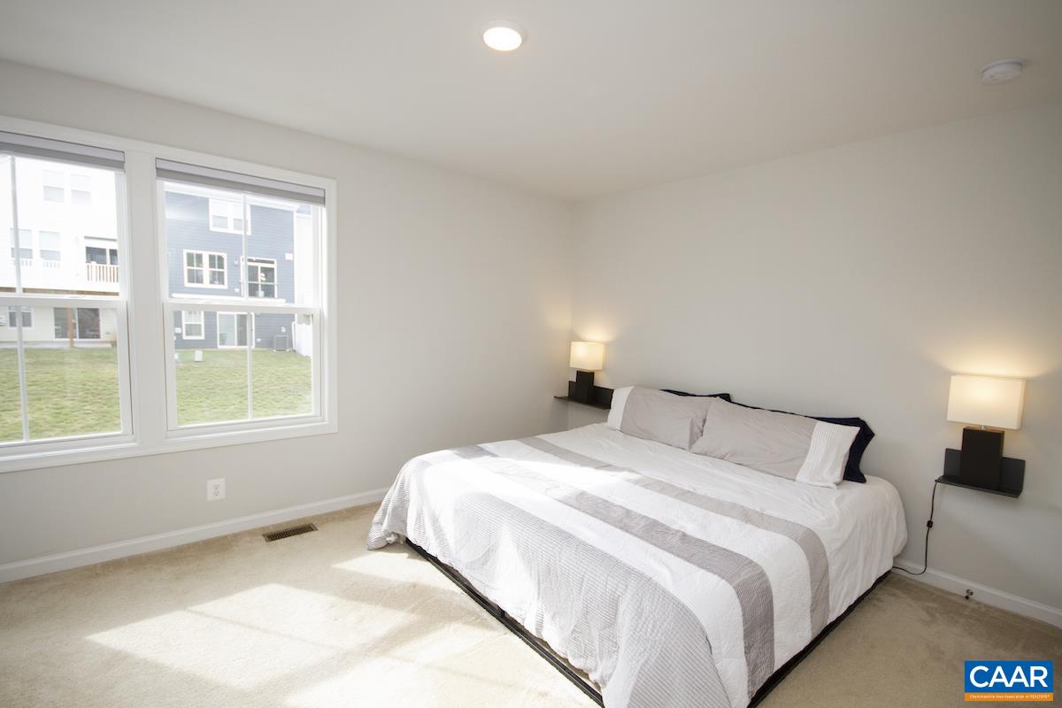 2174 Avinity Loop Charlottesville, VA 22902 - Photo 14 of 34 a bedroom with a bed and a window