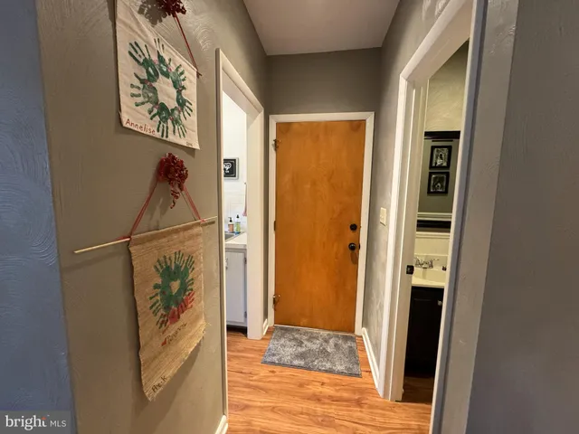 a view of hallway with wooden floor