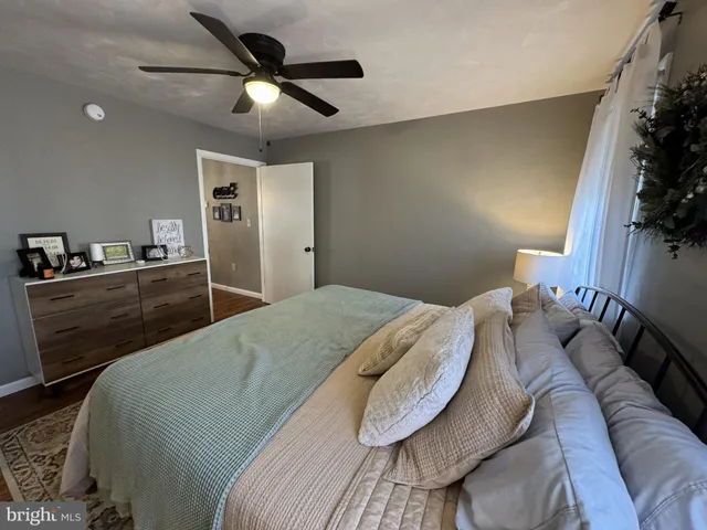a bedroom with a bed and a potted plant