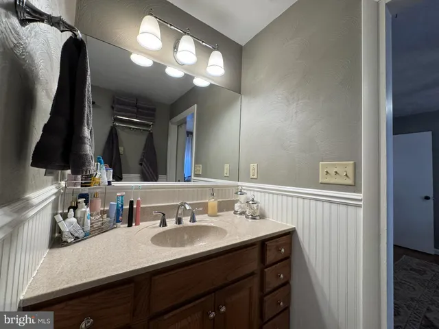 a bathroom with a sink vanity and a mirror