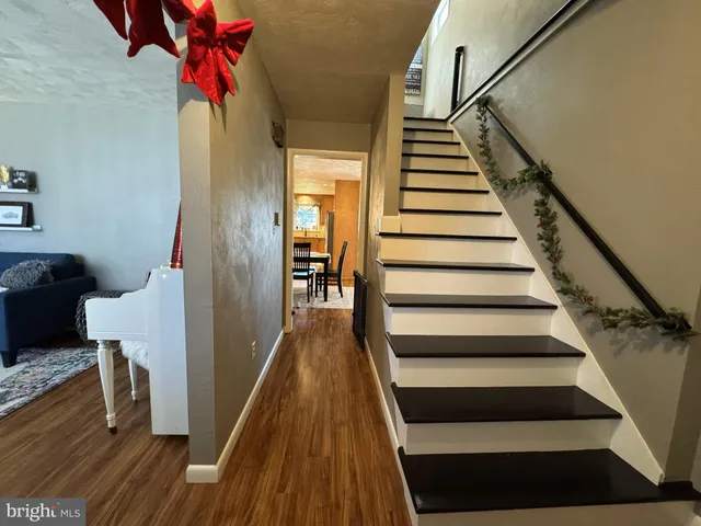 a view of entryway and gallery with wooden floor