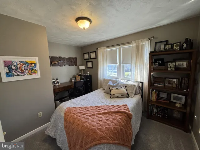 a bedroom with a bed and dresser